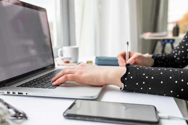 Side view business woman working on laptop