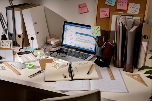 View of messy office workspace with laptop