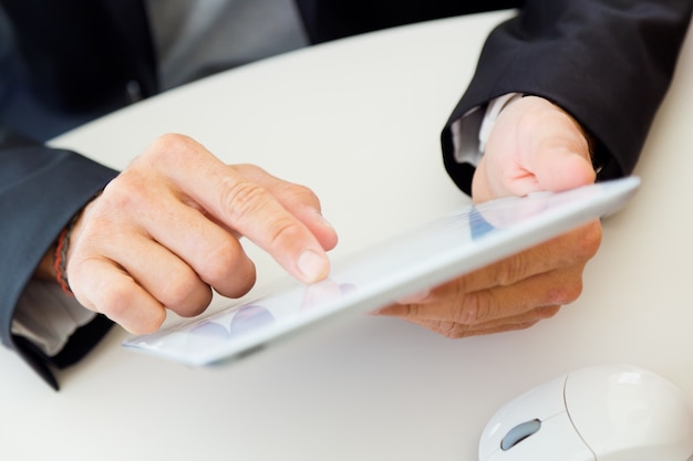 Man's hands using a tablet